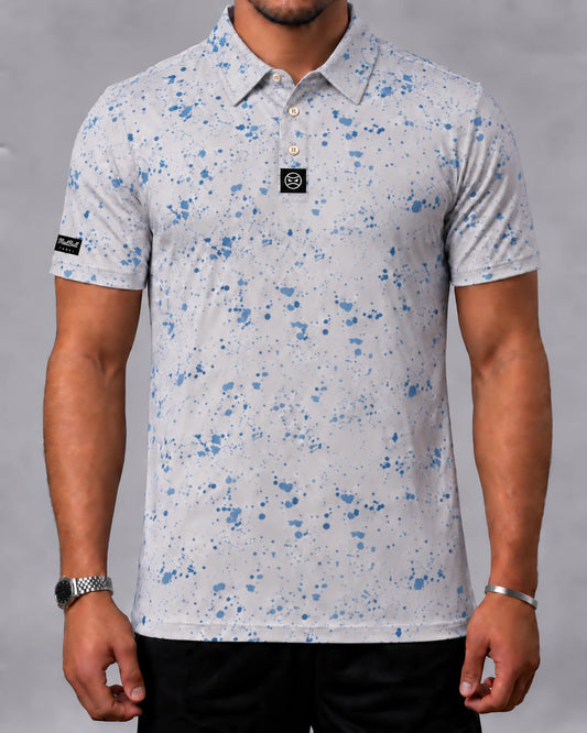 MADBALL Blue Splatter polo, front view with blue print on a light base and black signature labels.